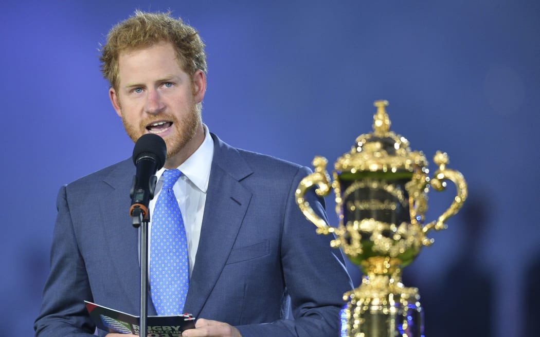 Prince Harry delivers a speech next to the Webb Ellis Cup during the opening ceremony.