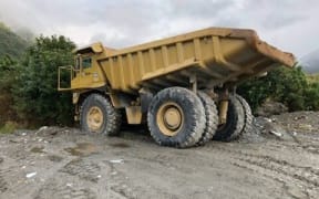 Truck helping transport people, cars across Waiho River