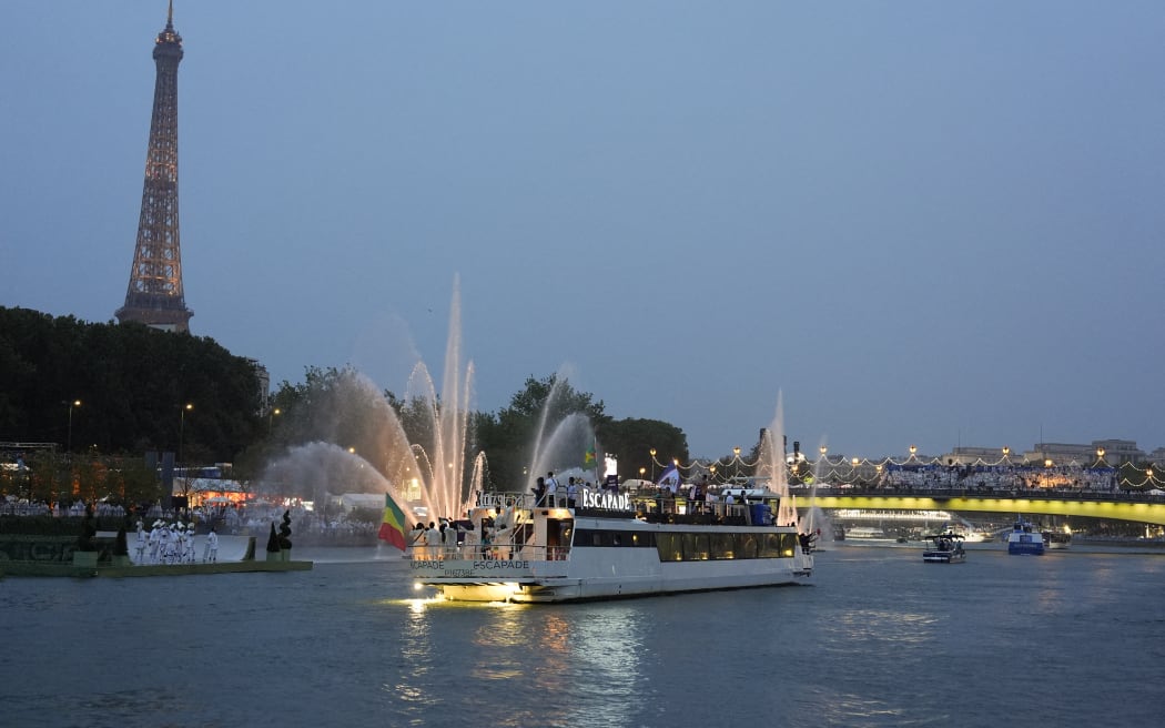 Delegations sail in boats along the river Seine during the opening ceremony of the Paris 2024 Olympic Games in Paris on July 26, 2024. (Photo by Morry Gash / POOL / AFP)