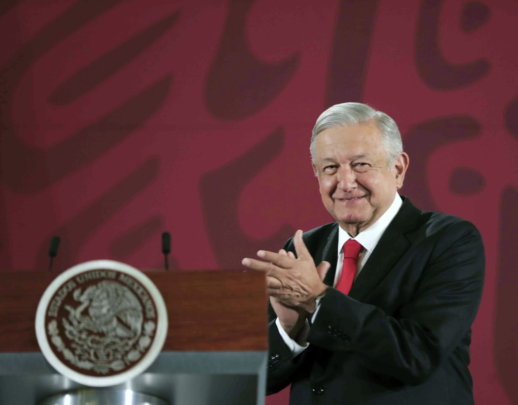 Handout picture released by the Mexican Presidency showing Mexican President Andres Manuel Lopez Obrador applauding during a press conference at the National Palace in Mexico City on December 27, 2019.