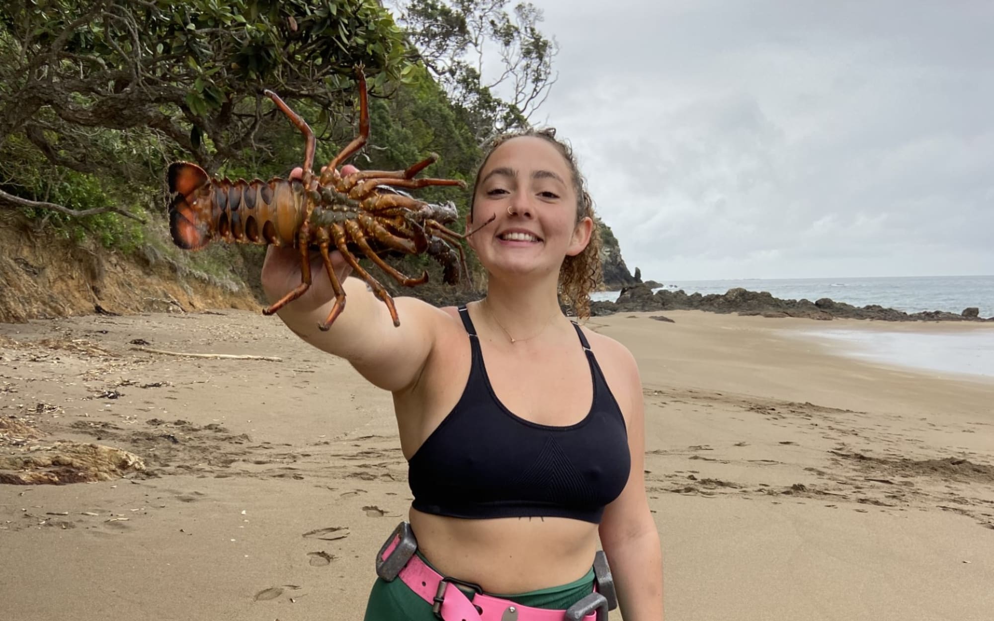 Ellie Franco and her first free-dive-caught crayfish at Daisy Bay, Matapouri.