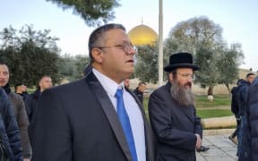 A handout picture courtesy of Minhelet Har-Habait (Temple Mount Administration) shows Israeli minister and Jewish Power party chief Itamar Ben-Gvir (C) walking through the courtyard of Jerusalem's Al-Aqsa mosque compound, known to Jews as Temple Mount, early on January 3, 2023. - The move by Ben-Gvir has enraged Palestinians, while the United States warned of steps which may harm the status quo. Al-Aqsa mosque is the third-holiest place in Islam and at the same time the most sacred site to Jews.