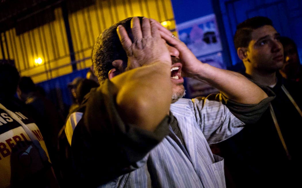 A bereaved father grieves for his dead sons at the Zynhom morgue in Cairo on 8 February 2015.