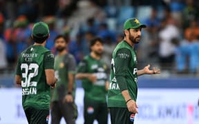 Pakistan's captain Salman Agha reacts after the India team refuses to shake hands after the Asia Cup cricket match in Dubai, September 14, 2025. (Photo by SAJJAD HUSSAIN / AFP)