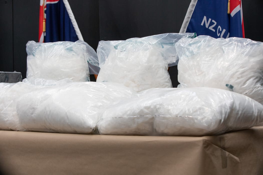 Two men have been arrested over an attempt to smuggle 110kg of methamphetamine and two handguns into New Zealand inside golf cart batteries.