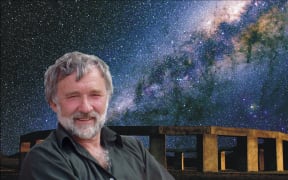 Astronomer Richard Hall stands in front of the replica Stonehenge he built in the Wairarapa with the milky way in the night sky.