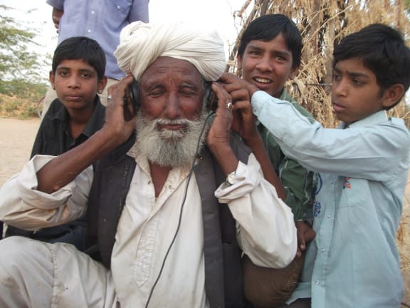 Hindal Khan listening to his recording