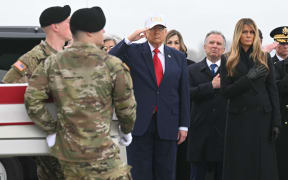 US President Donald Trump salutes as members of a US Army team carry the flagged-drapped transfer case containing the remains of US soldier Sgt. 1st Class Nicole M. Amor during a dignified transfer solemn event at Dover Air Force Base, in Dover, Delaware, on March 7, 2026. Six US Army soldiers were killed March 1 when an Iranian drone struck a key US command center in Kuwait's southern industrial hub of Port Shuaiba, a day after the United States and Israel launched a sweeping military campaign against Iran. (Photo by SAUL LOEB / AFP)