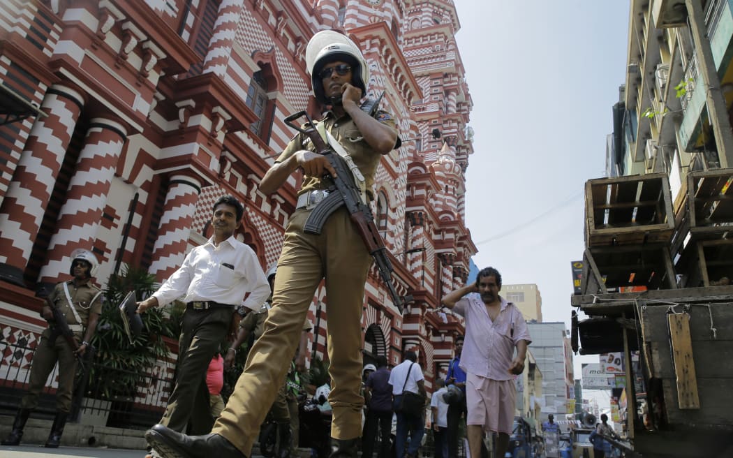 A Sri Lankan police officer patrols out side a mosque in Colombo, Sri Lanka, Wednesday, April 24, 2019.