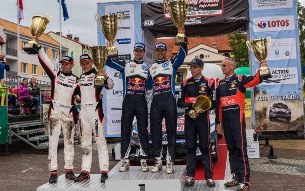 Hayden Paddon and John Kennard on the podium after a third finish at Rally Poland. July 2016