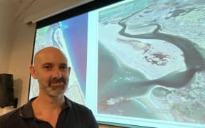 University of Auckland's Professor Dr Mark Dickson outlines the changes in Mangawhai sandspit over time including (second from left) when its northern entrance closed and a southern channel developed after a huge 1978 storm