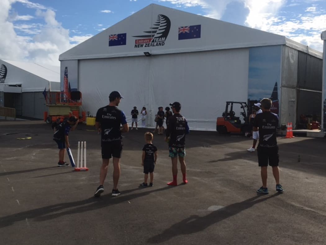 Members of Team NZ celebrate their history-making win with a game of cricket with their kids.
