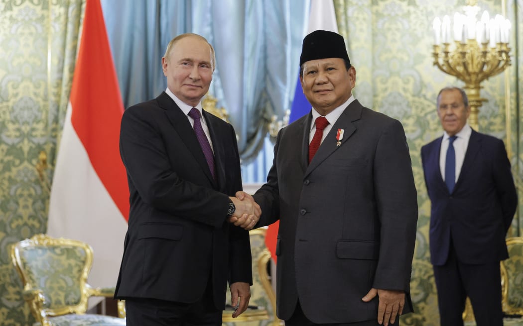 Russia's President Vladimir Putin (L) shakes hands with Indonesia's President-elect Prabowo Subianto as Russia's Foreign Minister Sergei Lavrov (R) looks on during a meeting at the Kremlin in Moscow on July 31, 2024. (Photo by Maxim Shemetov / POOL / AFP)