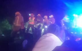 Emergency services at the scene of the bus crash south of Gisborne that claimed two lives.