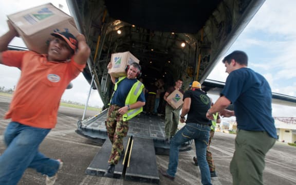 Aid is unloaded from a C-130 Hercules.