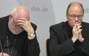 Archbishop of Munich and Chairman of the German Bishops' Conference and Trier Bishop, Cardinal Reinhard Marx (L) and commissioner for sexual abuse issues in the ecclesiastical sphere, Stephan Ackermann give a press conference.