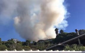 The scene of a blaze moving in on houses at Ahipara. Helicopters have been used tackle the huge bush blaze.
