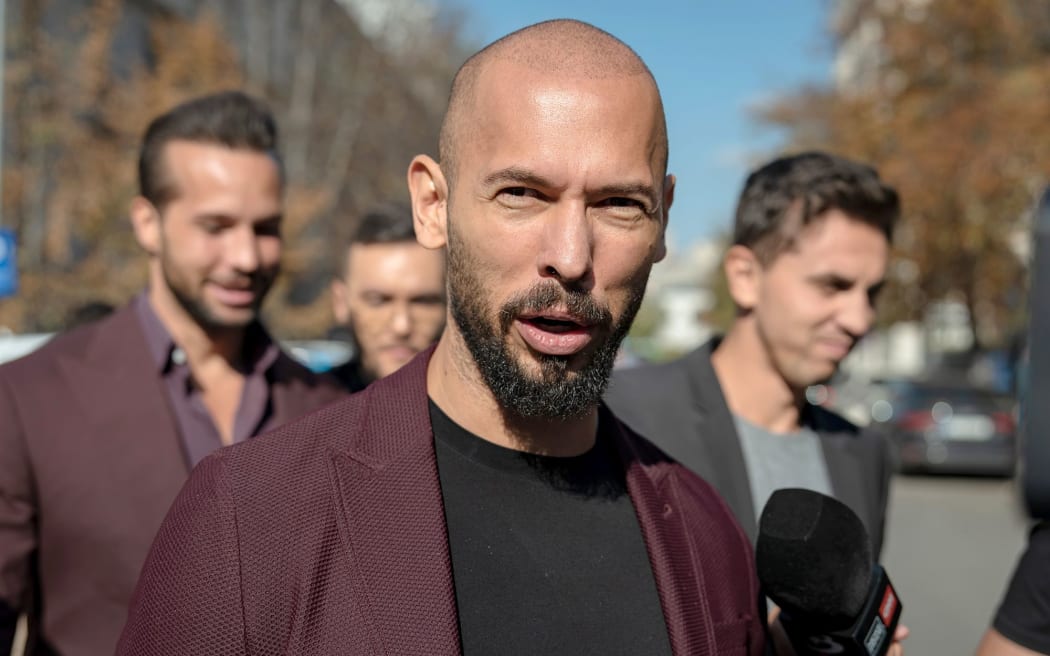 Andrew Tate talks to reporters outside the Court of Appeal on October 15, 2024 in Bucharest, Romania.