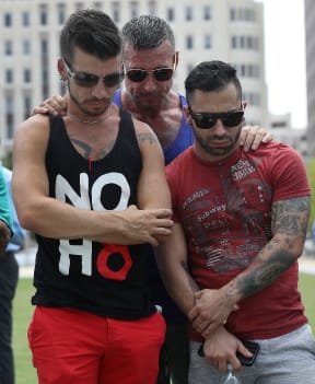 Chris Drozd, Don Raber and Stefan Salvatore (L-R) stand together as they visit a memorial at the Dr. Phillips Center for the Performing Arts for the victims of the Pulse gay nightclub shooting