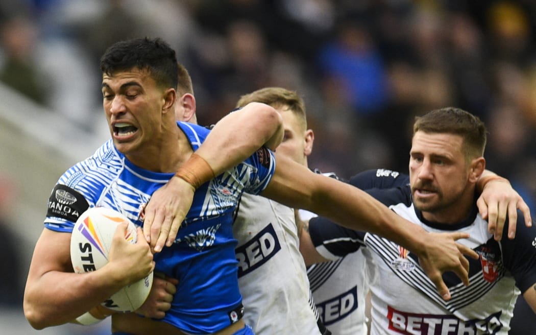 Samoa's Joseph Suaali'i is tackled during the 2021 rugby league World Cup men's opening match against England in Newcastle.