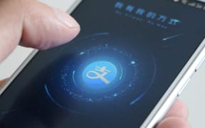 A Chinese mobile phone user with Alibaba's online payment service Alipay app.