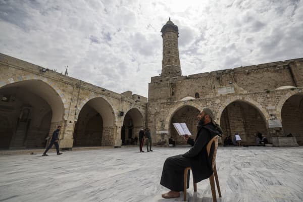 A Palestinian man reads the Koran at the Great Omari Mosque in Gaza City on the first day of the Muslim holy month of Ramadan on 23 March, 2023.