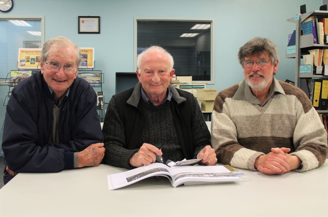 Dr Roger Frazer (left) shares his father’s military history with Ian Grant of Fraser Books and Wairarapa archivist Neil Frances (right) who is writing a book on the tens of thousands of soldiers who marched over the Rimutaka Hill before embarking for the Western Front in the First World War.