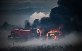Fire trucks burn in a wildfire on the Mont d'Arrees, outside Brasparts, western France on 19 July 2022.