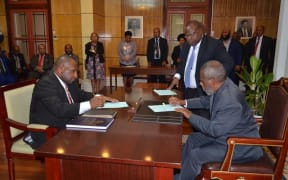 James Marape left being sworn in as prime minister of Papua New Guine by the governor general Sir Robert Dadae. 30 May 2019