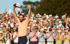 Scottie Scheffler celebrates on the 18th green after winning the 2024 US Masters.