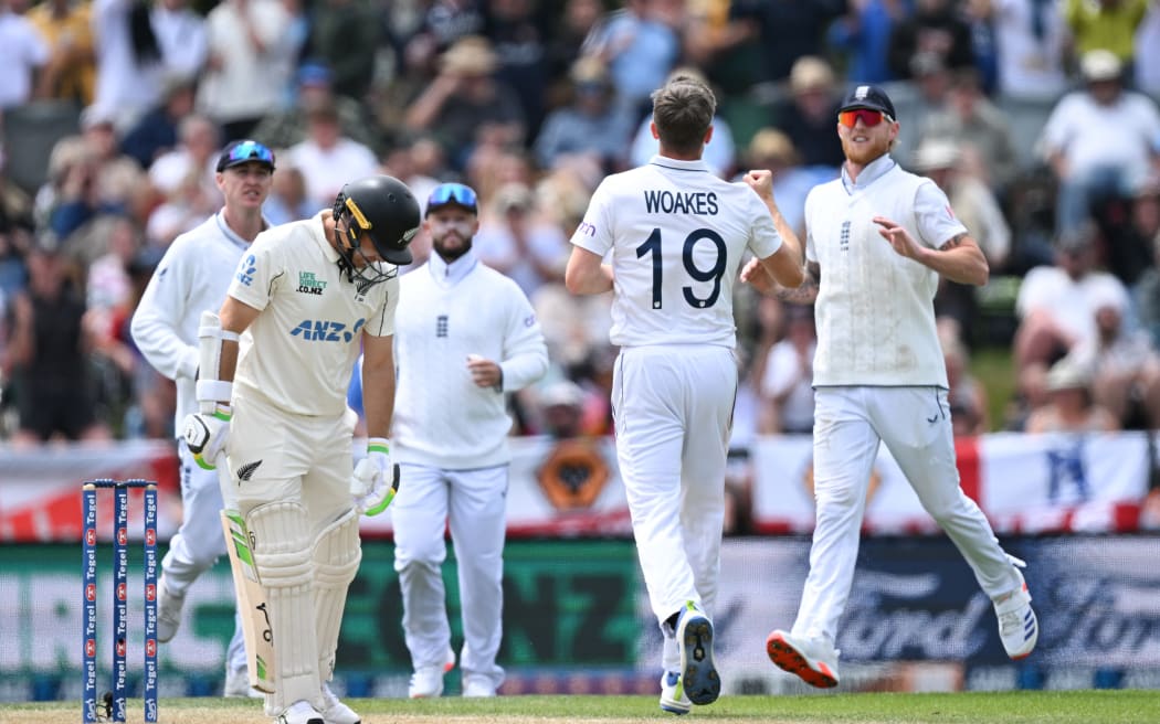 England bowler Chris Woakes celebrates with Ben Stokes the wicket of Tom Latham.