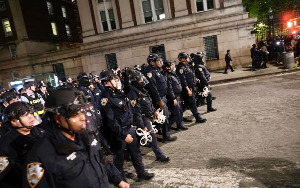 NYPD officers in riot gear march onto Columbia University campus, where pro-Palestinian students are barricaded inside a building and have set up an encampment, in New York City on April 30, 2024.