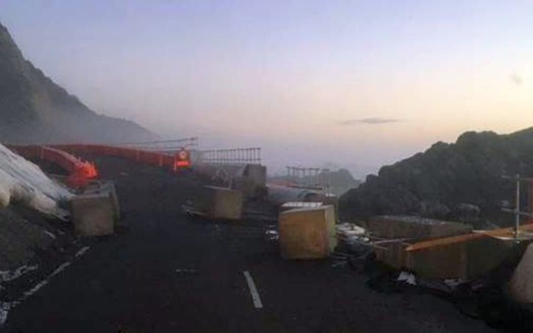 Temporary sea wall blocks on the road at Ohau Point.