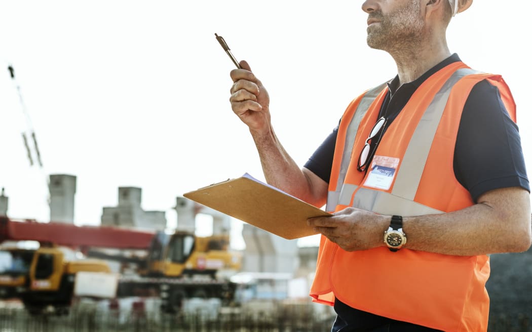 Man in high vis gear at building site.Architecture, Construction Safety, First Concept image.