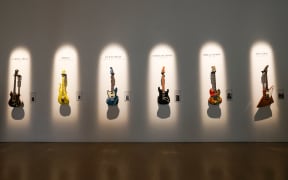 (L-R) Jerry Garcia’s guitar 'Tiger', Prince’s Andy Beech custom Yellow Cloud guitar, Kurt Cobain’s 1966 Fender Mustang guitar, David Gilmour’s 'Black Strat', Eric Clapton’s 'The Fool' Gibson SG and The Edge’s Gibson Explorer are displayed during a press preview of The Jim Irsay Collection at Christie’s Los Angeles in Beverly Hills.