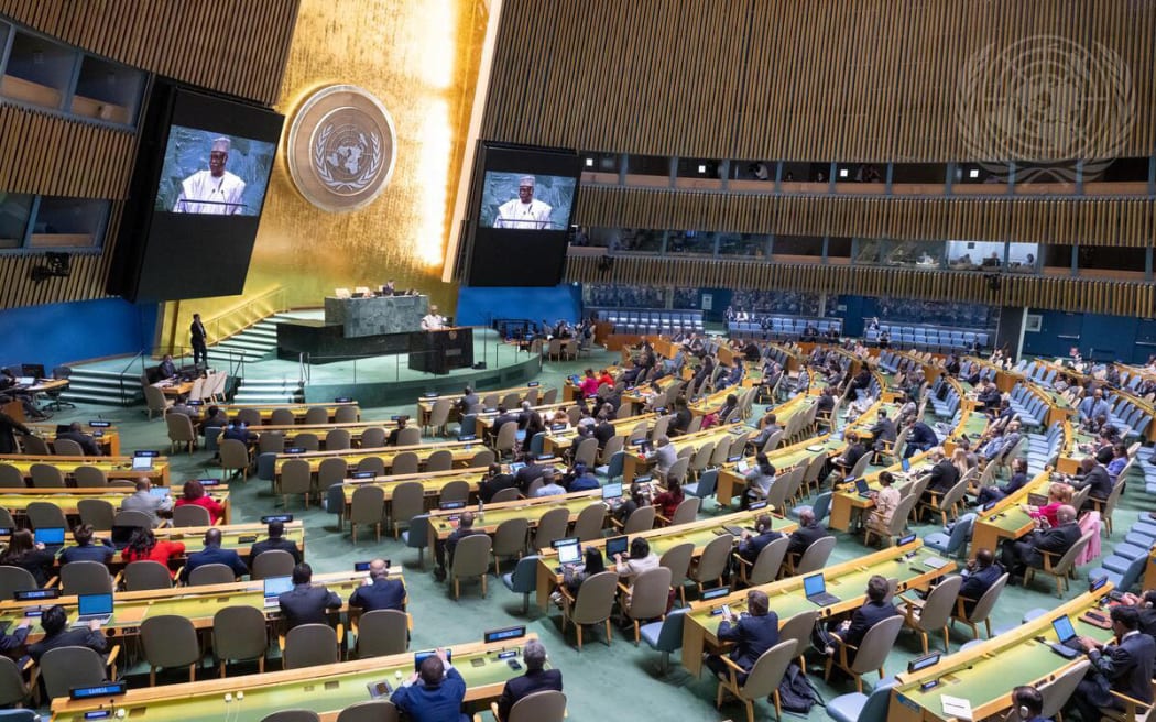 A wide view of the General Assembly Hall as Philemon Yang (at podium and on screens), President of the seventy-ninth session of the United Nations General Assembly, addresses the resumed 10th Emergency Special Session of the General Assembly on “Illegal Israeli actions in occupied East Jerusalem and the rest of the Occupied Palestinian Territory”.