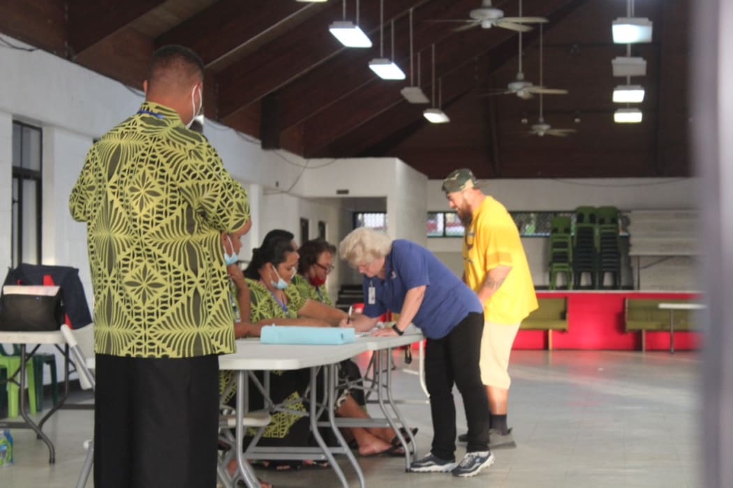 Electors sign the voter roll before casting ballots at the Ili’ili village polling station, today, during the American Samoa General
election. 4 November 2020