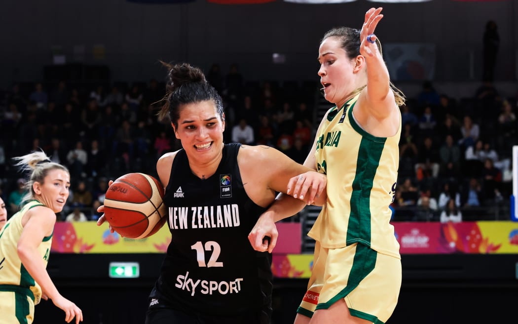 Penina Davidson of New Zealand drives to the basket guarded by Keely Froling of Australia during the FIBA Women's Asia Cup Bronze Medal basketball match between Australia and New Zealand at Quaycentre in Sydney, Sunday, July 2, 2023.