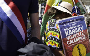 France, Paris, 2025-05-10. A woman carries a placard with the text ‘170 years of French colonisation is enough. Independence for New Caledonia and support for the Kanak people’. In memory of the 19 Kanaks killed in Ouvea by the French colonial state and the Kanak children and activists murdered in Noumea during the uprising on 13 May, a united march was organised. Photograph by Eric Broncard/Hans Lucas
France, Paris, 2025-05-10. Une femme porte une pancarte avec le texte «170 ans de colonisation Francaise ca suffit. Independance Nouvelle-Caledonie Soutient du peuple Kanak». En memoire des 19 Kanaks tues a Ouvea par l’Etat colonial francais et des enfants et militants kanaks assassines a Noumea lors de la revolte du 13 mai, une marche unitaire est organisee. Photographie par Eric Broncard/Hans Lucas (Photo by Eric Broncard / Hans Lucas / Hans Lucas via AFP)