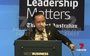 A screenshot from 7 News footage shows Qantas chief executive Alan Joyce with his face covered with pie.