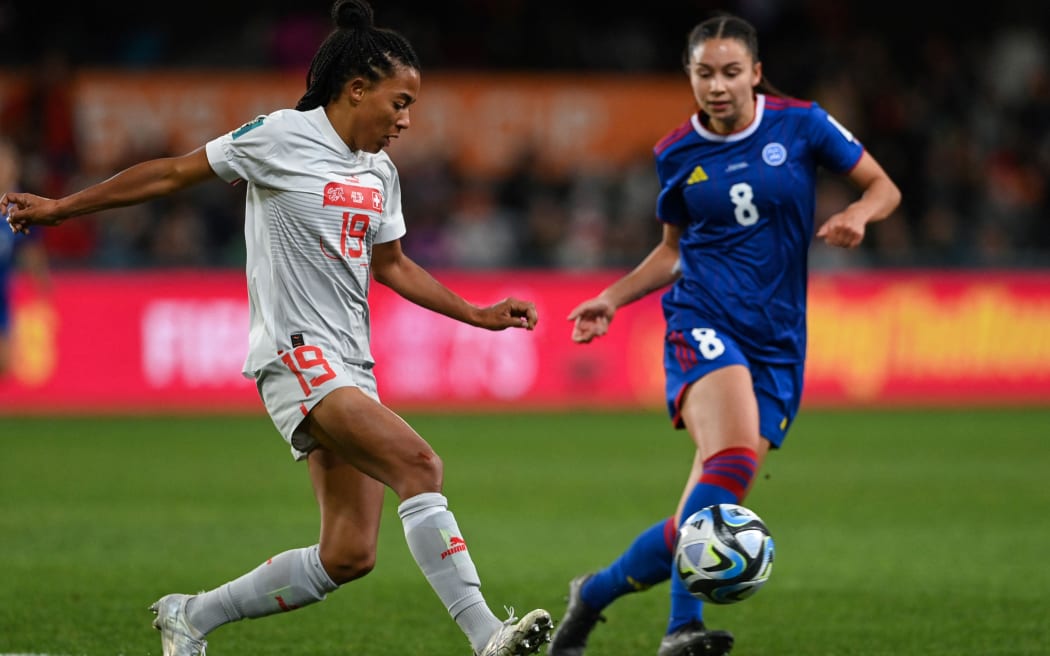 Switzerland's forward #19 Eseosa Aigbogun (L) and Philippines' midfielder #08 Sara Eggesvik vie for the ball during the Australia and New Zealand 2023 Women's World Cup Group A football match between the Philippines and Switzerland at Dunedin Stadium in Dunedin on July 21, 2023. (Photo by Sanka Vidanagama / AFP)