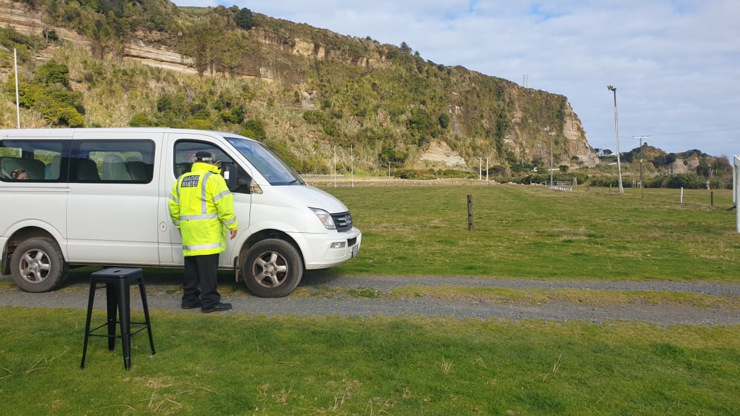 A Māori warden gives parking advice at the Mōkau pop-up clinic.