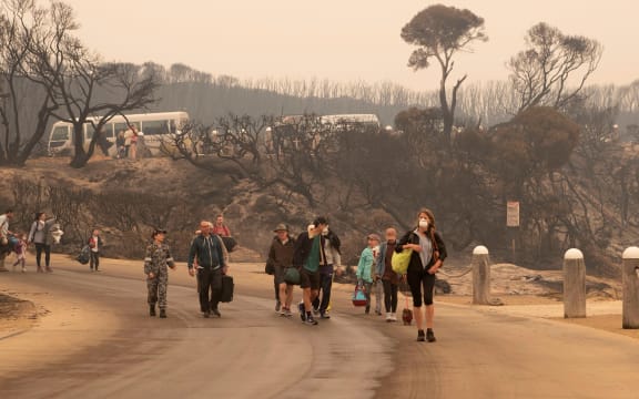 Evacuees walking to the beach to board a navy ship to escape fires at Mallacoota, Victoria, on 3 January 2020.