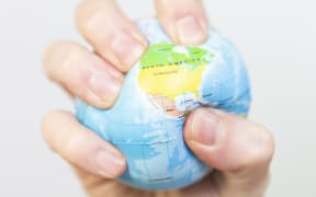 Stress ball 
A man gripping a stress ball in the shape of the earth. 

COLLANGES / BSIP (Photo by COLLANGES / BSIP / BSIP via AFP)