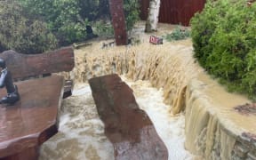 A fast-moving, dirty river of water enters the Aubrey Road property of Lou Harper and Helen Henson, at approximately 8am on Monday, 1 July, 2024.