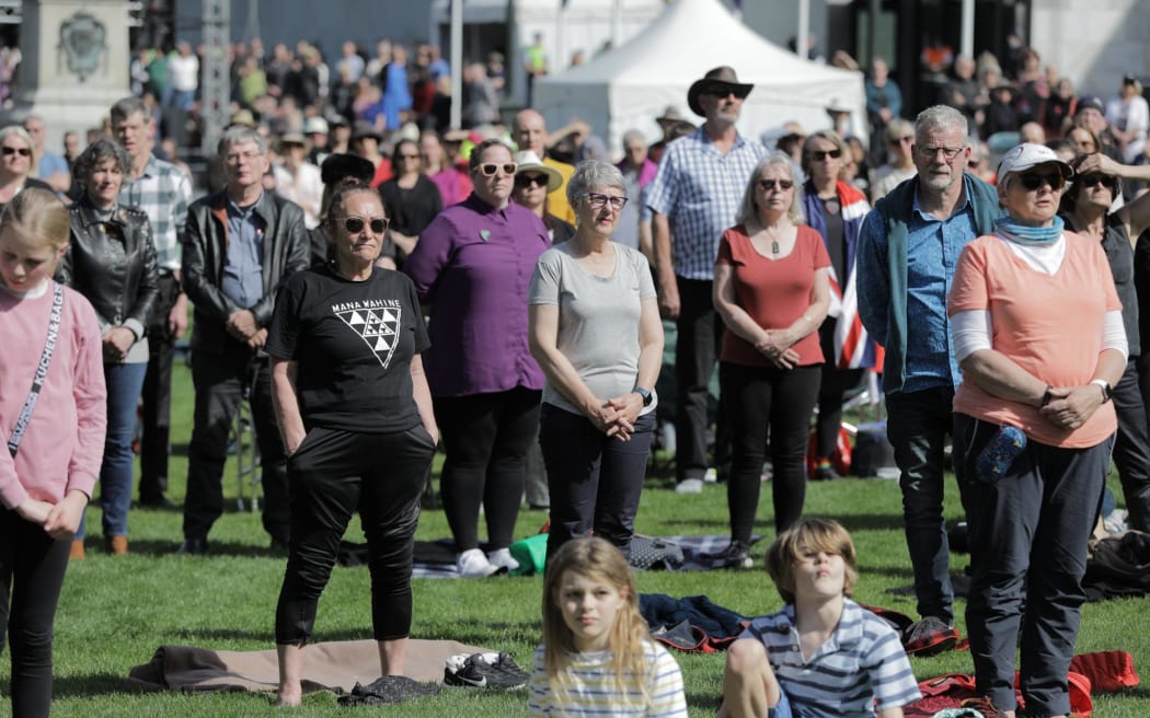 People stand as the congregation declares 'God save the King'.