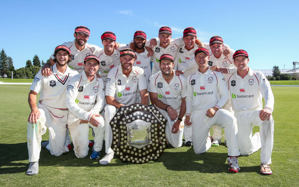The victorious Canterbury cricketers celebrate with the Plunket Shield