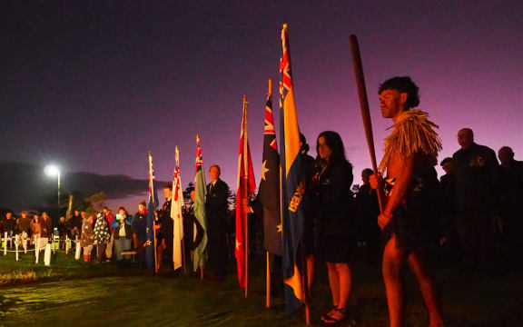 Joshua-James Young, of Kerikeri High School’s kapa haka group Te Pou o Manakō, stands guard over the flag bearers during Kerikeri's dawn service.