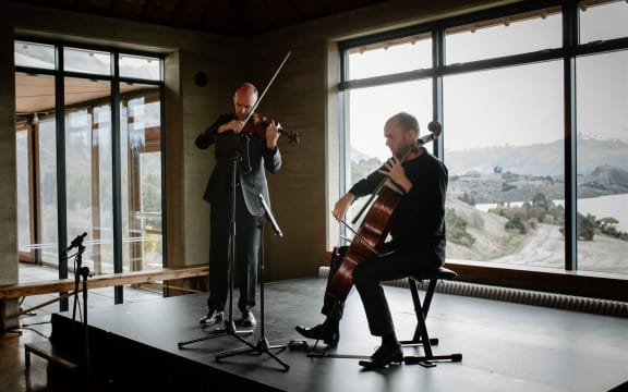 Violinist and cellist performing on stage in Rippon Hall.