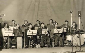Doug Kelly's Radio Band playing at Christchurch's first Jazz Concert in 1951. Doug Kelly on the far left on trumpet. Gerald Marston is first on the left in back row. Doug Caldwell at the piano.